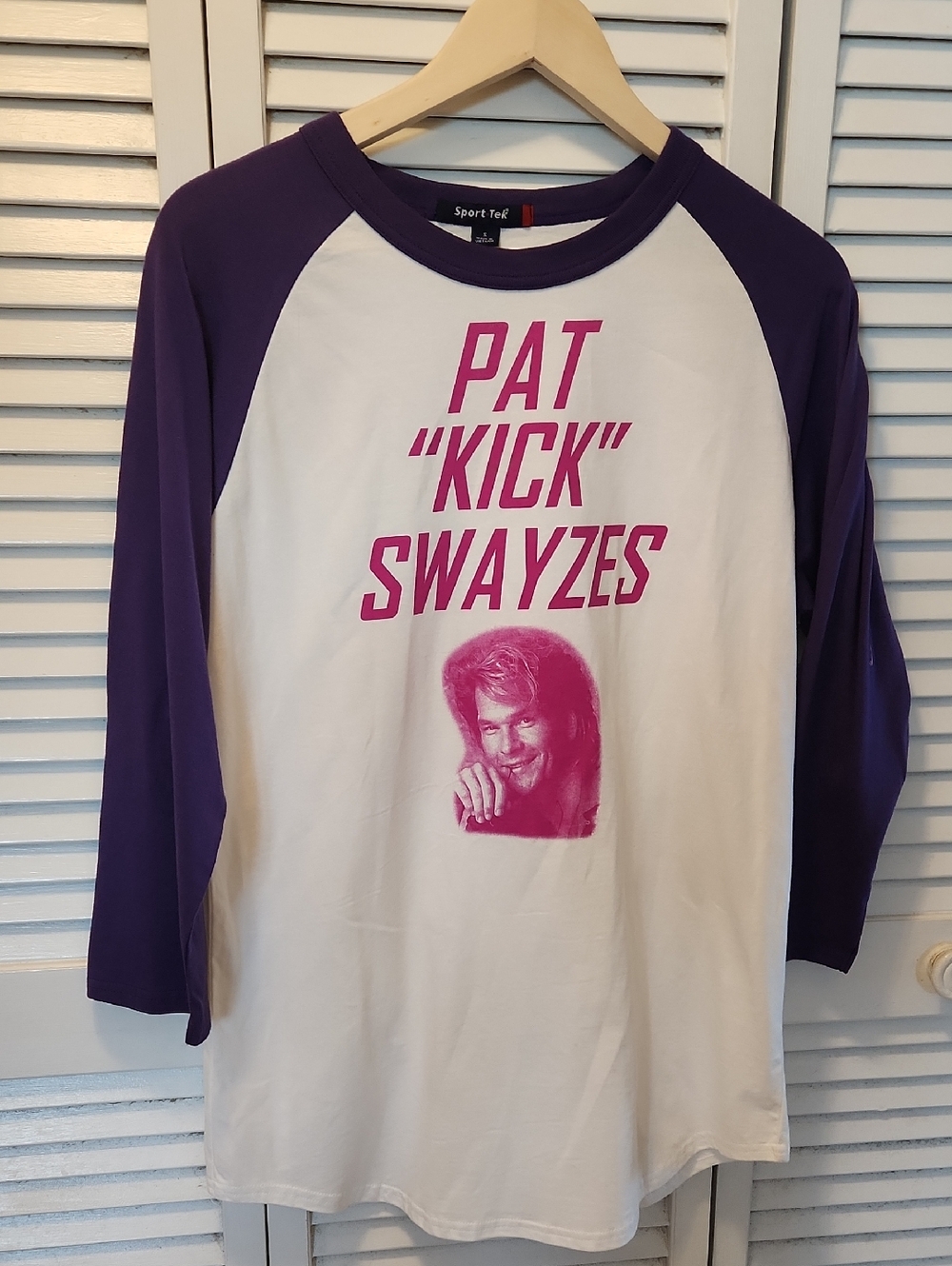 PATRICK SWAYZE    One Of A Kind  Sport-Tek White Tee with Purple Raglan Sleeves.